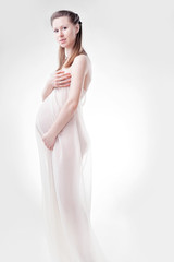 Fototapeta premium The pregnant woman in studio
