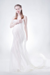 Fototapeta na wymiar The pregnant woman in studio