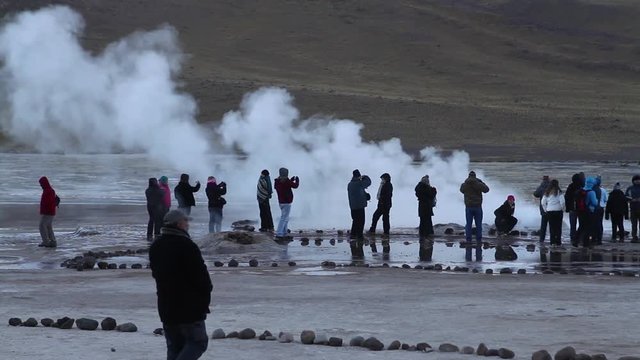 Tourists watching geysers
