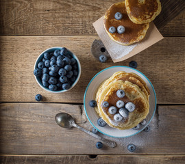 Some pancakes with blueberry on the wood table