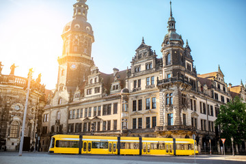 Plakat View on the old castle with Hausmannsturm tower and yellow tram in Dresden city during the sunrise in Germany
