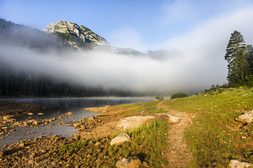 Morning mist over lake and mountain, Black lake, Durmitor national park