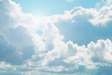 A blue sky with beautiful large fluffy clouds on a sunny and clear day.
