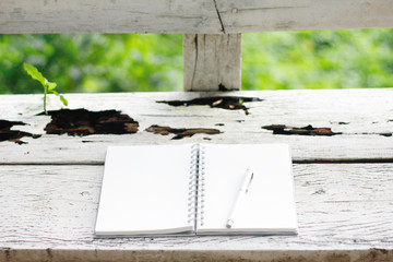 Stock photo :.Open Notebook and white pen on old wooden background.