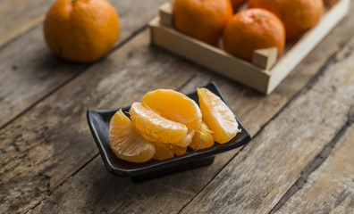 Ripe mandarine citrus . tangerine mandarine orange on wooden background. Mandarins in plate