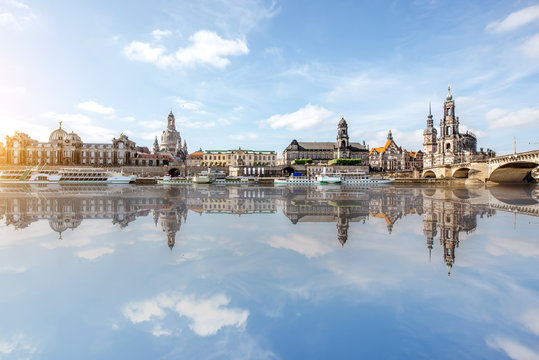 Panoramic view on the riverside of the old town with beautiful reflection on the water during the sunny weather in Dresden city, Germany