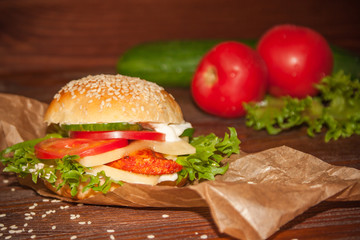 fresh and tasty burger on a old wooden background