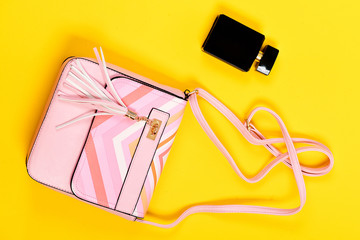 Purse in light pink color and perfume. Fashion and glamour