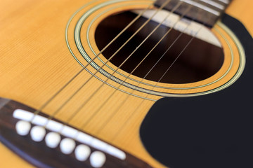 Fototapeta premium closeup acoustic guitar with soft-focus and over light in the background
