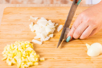 Cook cuts onions with a knife
