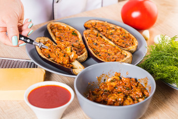 The cook fills the eggplant