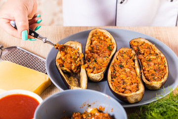 The cook fills the eggplant