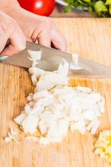 Cook cuts onions with a knife