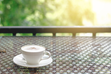 Stock photo :.Cappuccino coffee on vintage table in nature and sunlight background