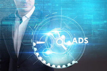 Business, Technology, Internet and network concept. Young businessman working on a virtual screen of the future and sees the inscription: ADS