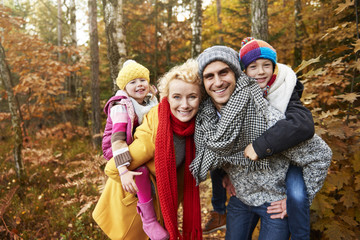 Picture of parents piggyback their children
