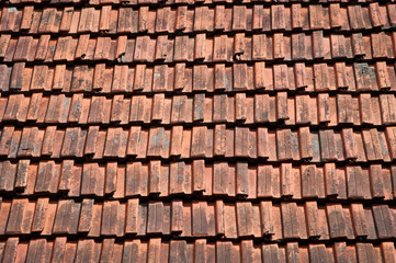 old weathered roof with red tiles