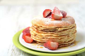 freshly prepared pancakes with strawberries