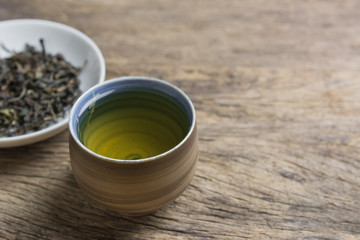 cup of chinese tea on old and crack  wooden surface