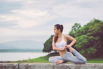 Naklejka na ściany i meble Asia woman doing yoga fitness exercise