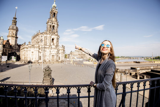 Young woman tourist enjoying great view on the Schlossplatz in Dresden during the morning light in Germany