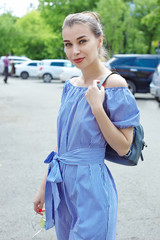 portrait 20-year-old woman in white and blue striped dress