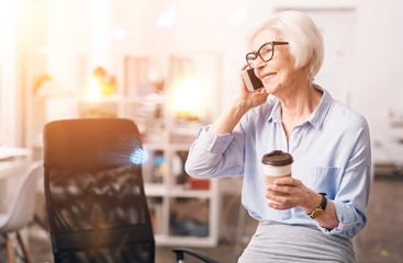 Charismatic respected businesswoman chatting on the phone