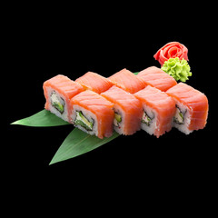 Japanese cuisine. Sushi roll with tasty fresh ingredients over dark background