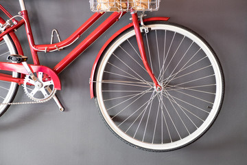 Vintage red bicycle hanging on wall
