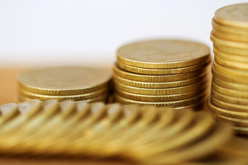 Row of coins on wood background for finance and Saving concept,Investment, Economy, Soft focus and dark style.