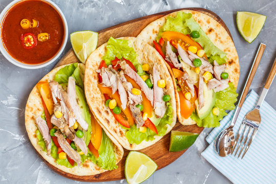 Fajitas with chicken, vegetables and spicy sauce salsa.