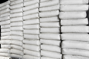 Pile of white plastic sacks in warehouse