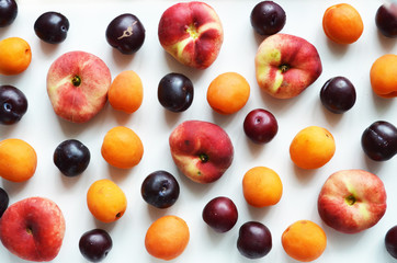 Delicious ripe summer fruits on a white background.