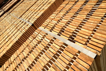 Stack of new wooden boards. Wooden plates on piles. Background texture.