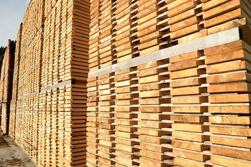 Stack of new wooden boards. Wooden plates on piles. Background texture.
