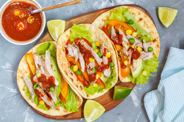 Fajitas with chicken, vegetables and spicy sauce salsa.