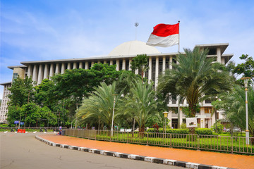 Jakarta view. Istiqlal Mosque with the indonesian flag, the largest Mosque in Jakarta city, Java island, Indonesia, Asia.