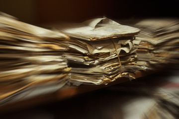 Old dusty stack of papers, files, documents on the shelves of archive room with zoom effect
