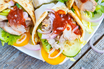 Meat wraps or fajitas with pork and vegetables.