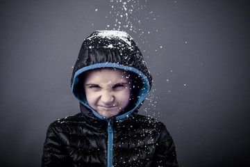 Spoiled adorable little boy in winter clothes - obrazy, fototapety, plakaty