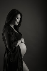  beautiful pregnant woman holding hands on her big belly.Pregnancy motherhood concept