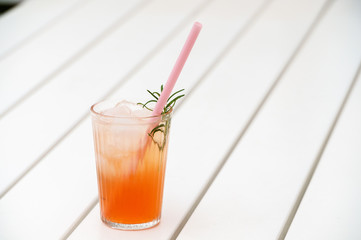 Fresh cold ice drink on white wooden surface