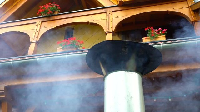 Smoke from the barbecue furnace tube slow motion view