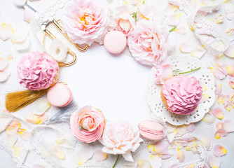 Pink cupcakes with roses and holiday decor in frame. Festive and bright. Wedding Celebration concept. Copy space.