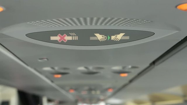 Close-up of Fasten Seatbelt Sign on Commerical Aircraft