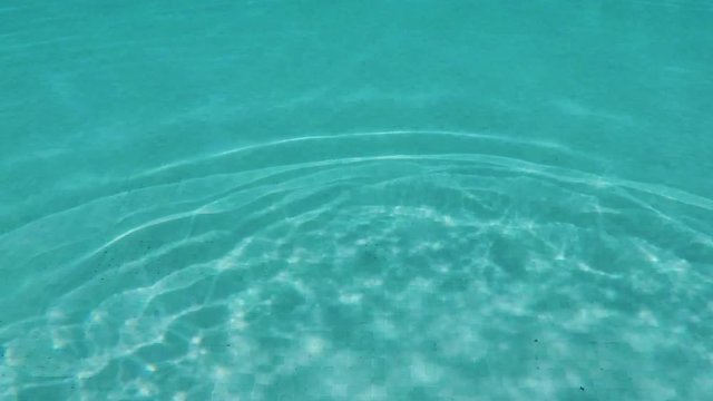 Detail of the water surface with sun reflection in the pool - sunny - slowmotion