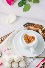 Coffee and candy in bed breakfast in hotel room.