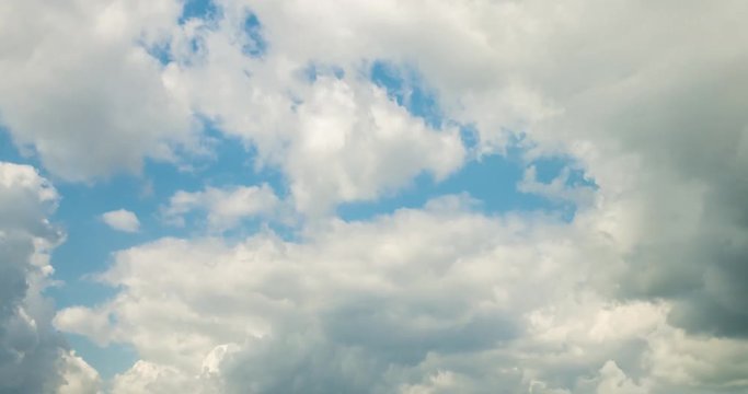 Time lapse clip of white fluffy curly rolling clouds
