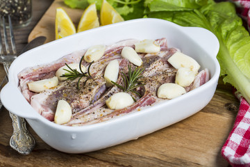 Raw lamb chops with spices and herbs close-up on wooden background