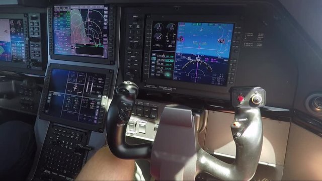 Private airplane cockpit - closeup of modern avionics (screen and joystick) 